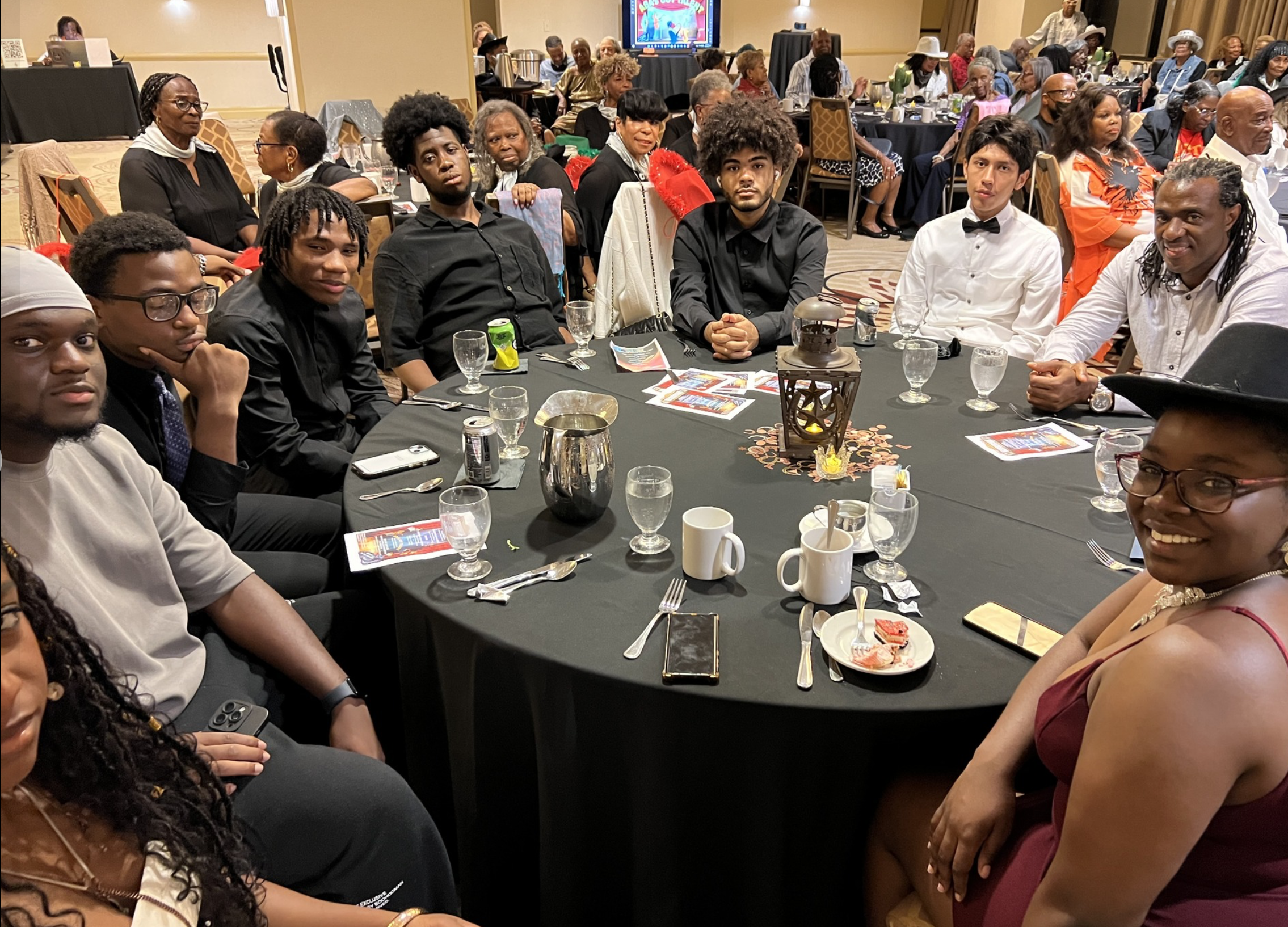 Eight young ABA players at a round banquet table during the Summer National.